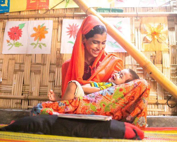 Mother and child in Bangladesh laughing.