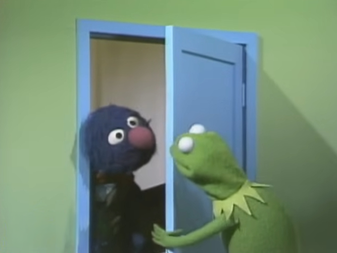 Kermit answering the door for Grover.