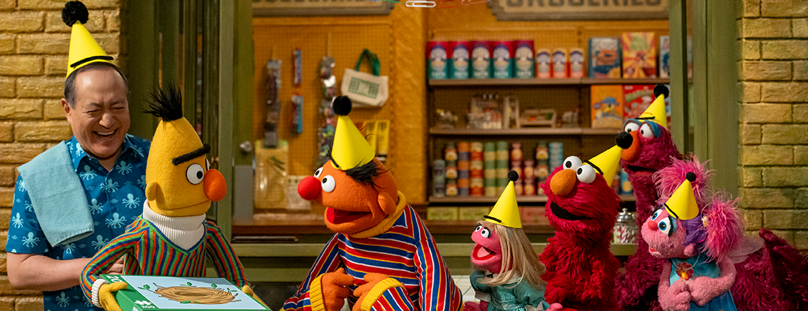 Alan, Bert, Ernie and Friends wearing party hats.