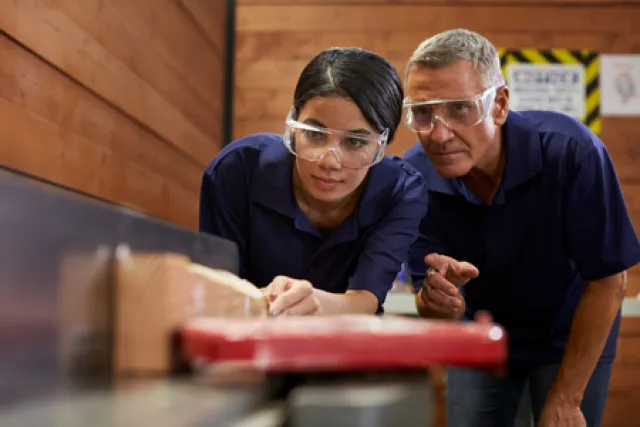 An instructor teaches an apprentice