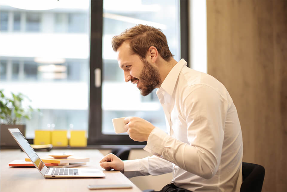 a man work while drinking coffee