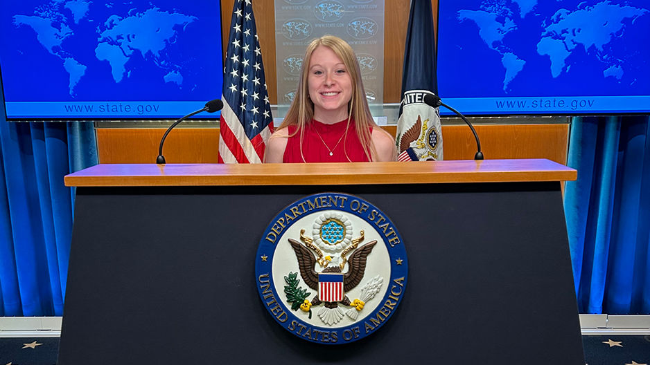 Tyler Mergen standing at podium at internship