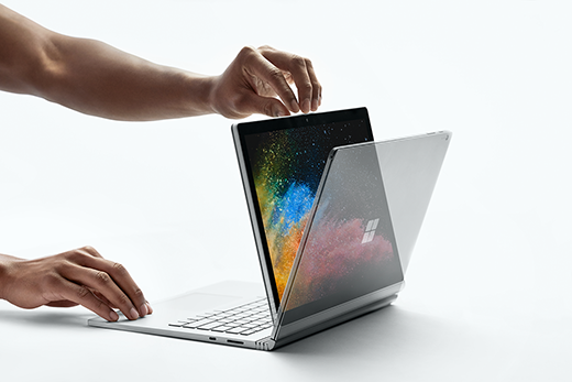 Billede af en hånd, der åbner en Surface Book 2, mens du er i visningstilstand.