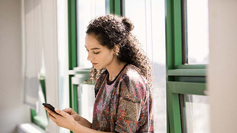 Image of a woman holding a phone.