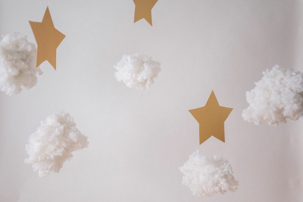 Stars and clouds against a grey background