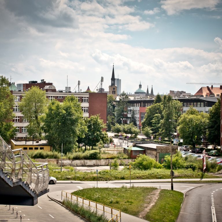 A view of a city with a bridge in the foreground