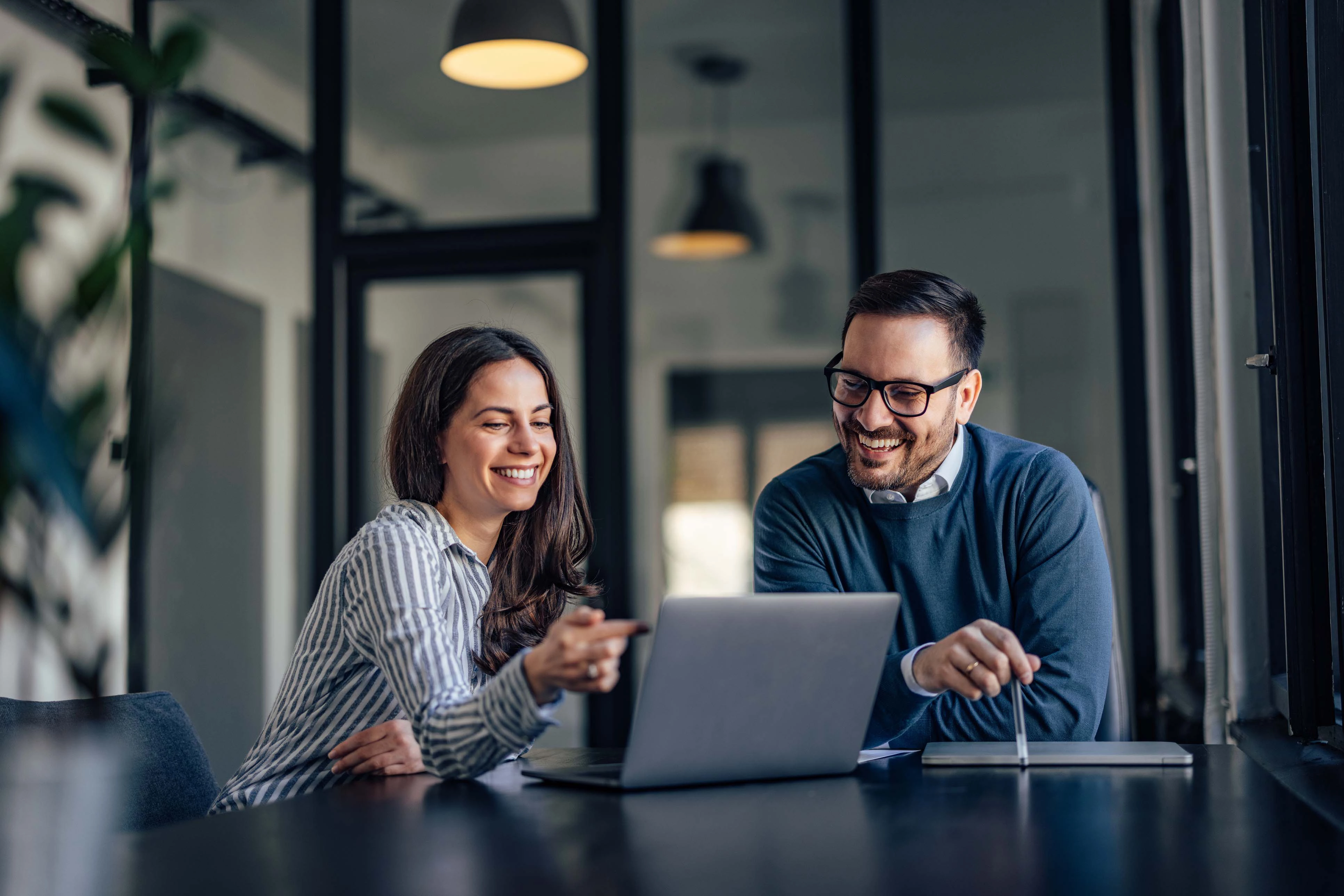 two people looking at laptop