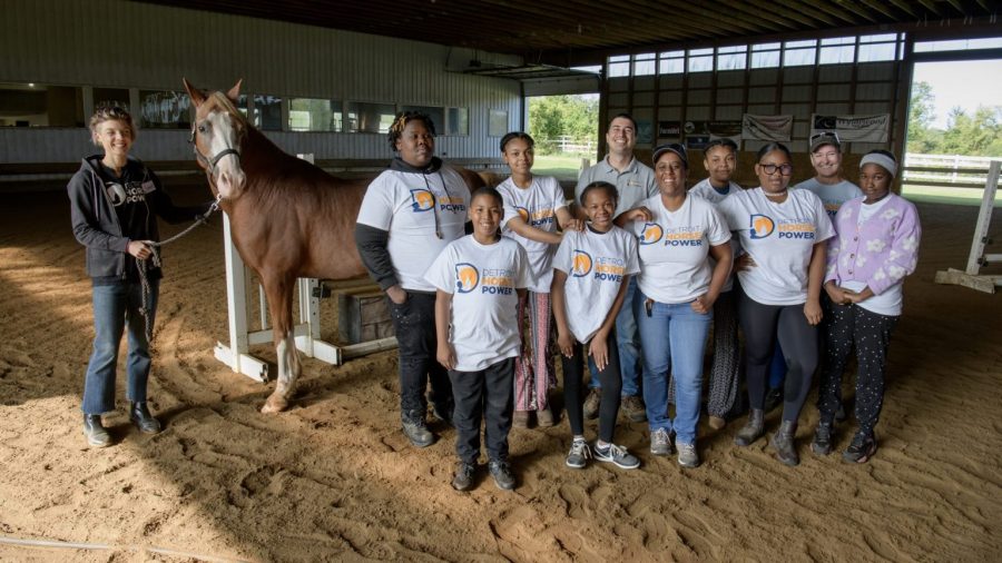 Detroit Horsepower Director David Silver (center) poses in the riding ring at Willowbrooke Farm in Plymouth, Mich., with members of the staff and a new class of eager young riders.