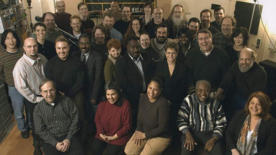 Former WDET Program Director Judy Adams (front and center in red) poses alongside her colleagues at WDET Studios.