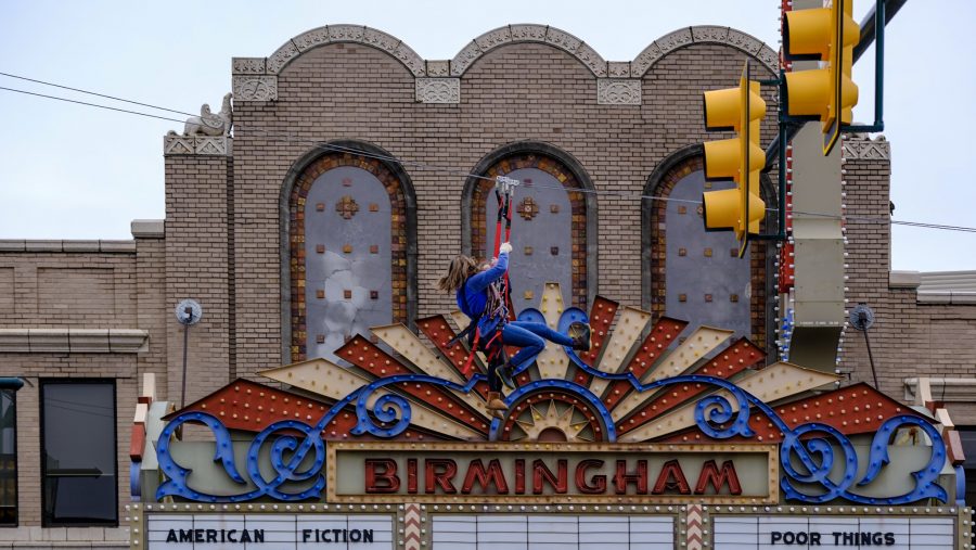 Someone ziplines through downtown Birmingham.