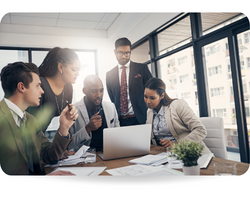 Shot of a group of young business people using a laptop together during a meeting in a modern office