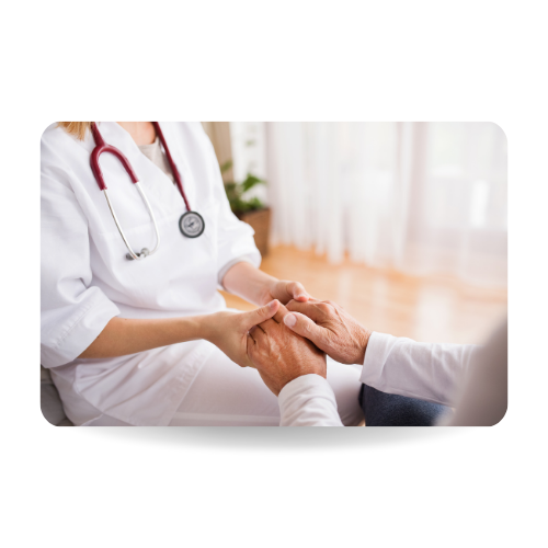 Unrecognizable health visitor and a senior man during home visit. A nurce holding hands of a man.