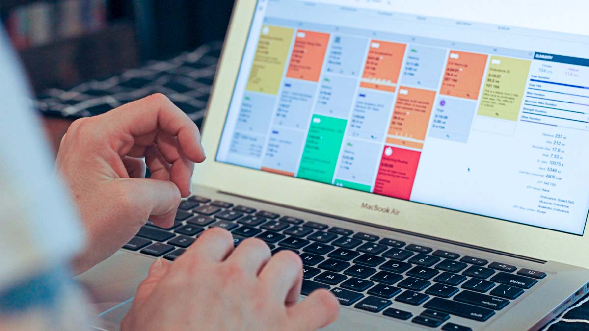 An Athlete Working On A Laptop Looking At Their Trainingpeaks Calendar In The App