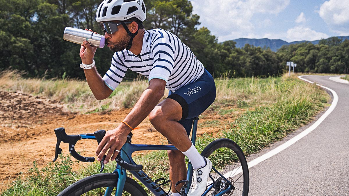 Cycling Endurance Athlete On The Bike Riding Down The Road Practicing Fueling Strategy