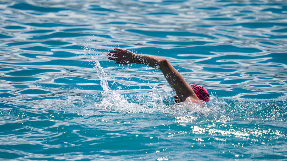 A Swimmer In The Blue Water Of The Pacific Ocean Near Kona, Hawaii.