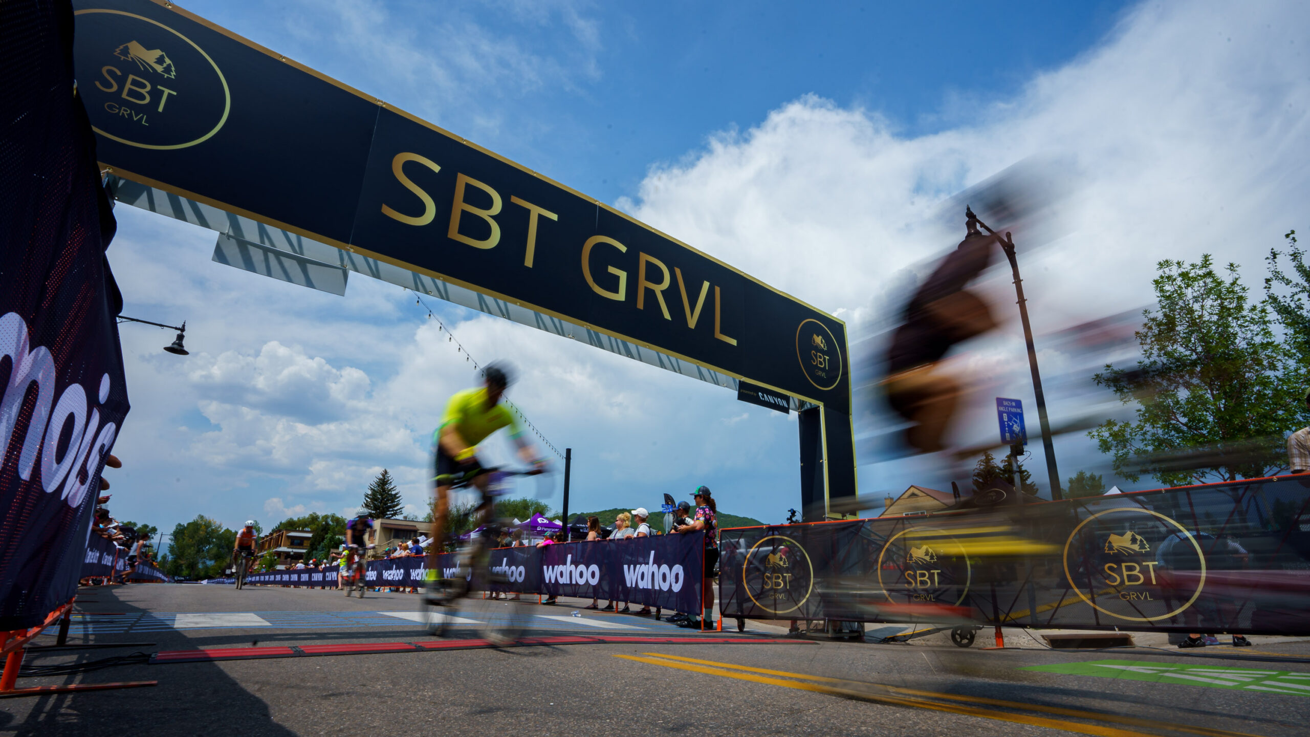 Photo At The Finish Line Of The Sbt Grvl Race In Colorado As Two Riders Cross The Timing Mat