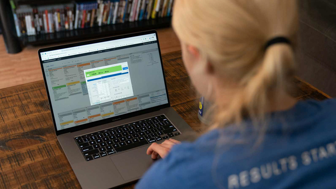 Image Of Coach With Laptop Looking At Trainingpeaks Screen