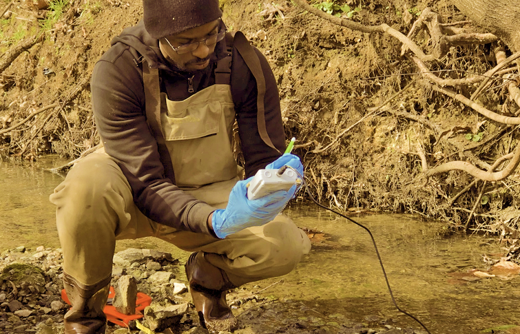 Austin Gray takes measurements of checmicals in a stream for his Ph.D. research. NC WRRI supported Gray's research through a joint grant with North Carolina Sea Grant.