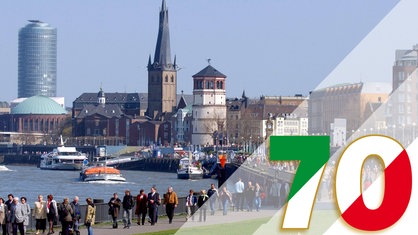 Spaziergänger in Düsseldorf an der Rheinpromenade.