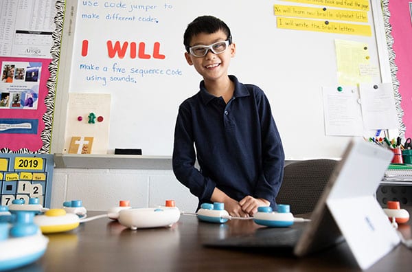 Smiling child with Code Jumper