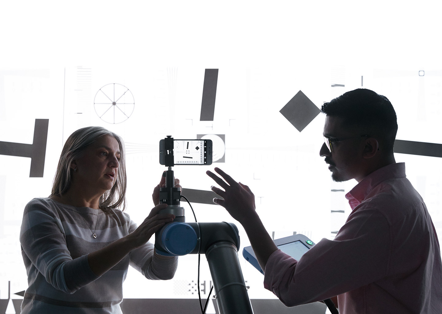 Two employees from the camera team collaborate in a lab