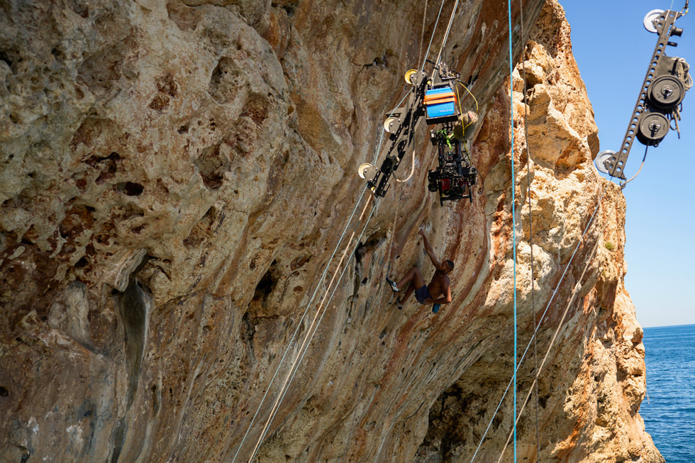 A behind-the-scenes shot of a camera on a pulley system shows the making of the “Deep Water Solo” episode of “Adventure.”