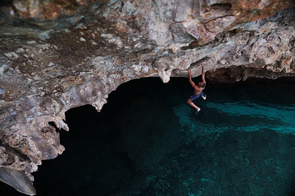 Kai Lightner hangs from a seaside crag in the “Deep Water Solo” episode of “Adventure.”