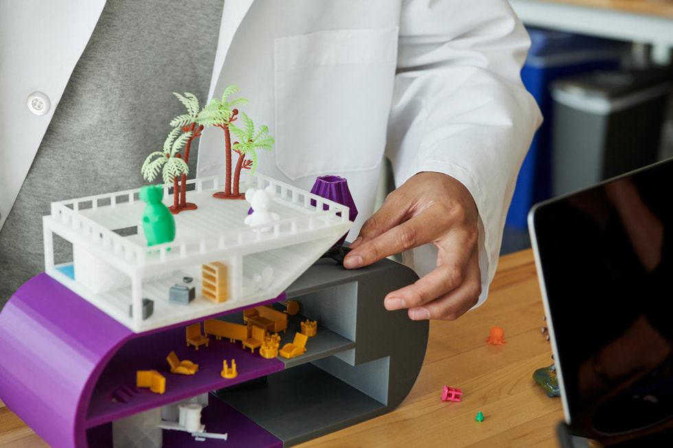 A student creates a building model in a science lab.