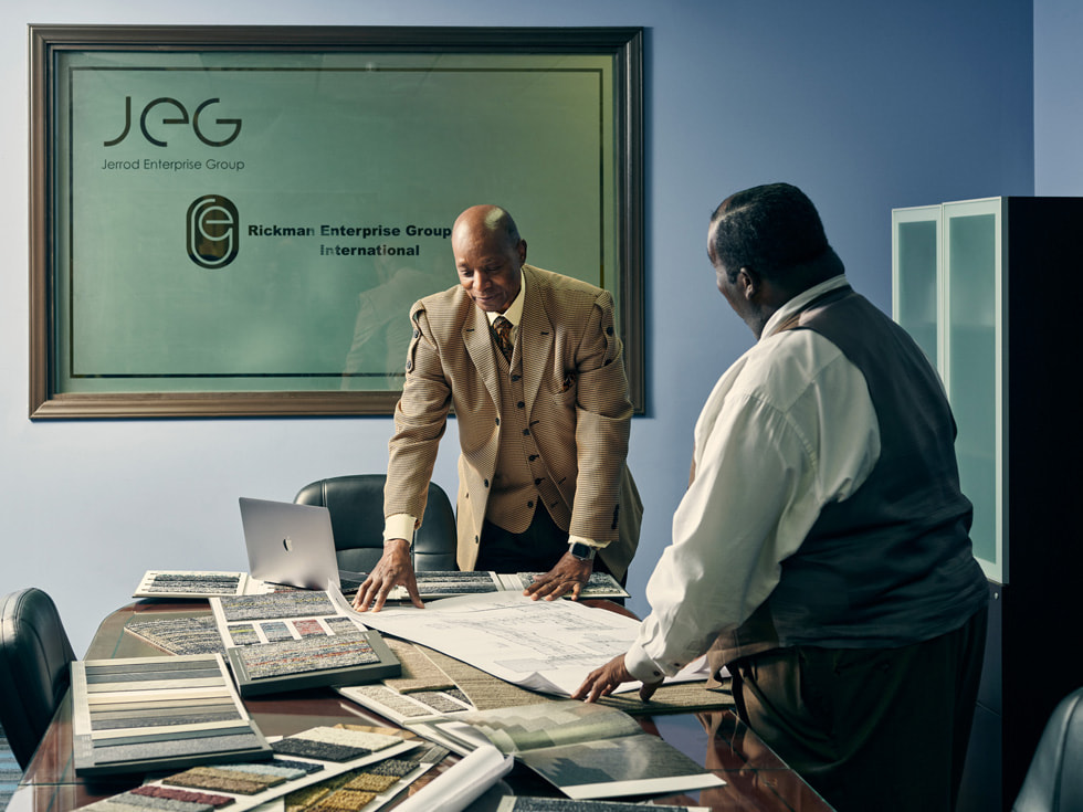 Roderick Rickman inside his office discussing plans on his desk.