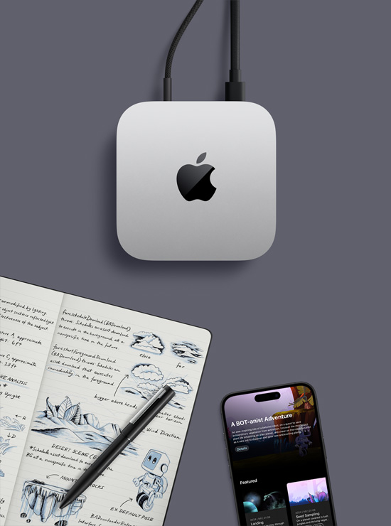 Top-down view of silver Mac mini with Apple logo, in a desk setup next to an iPhone, a pen and an open notebook showing handwritten notes