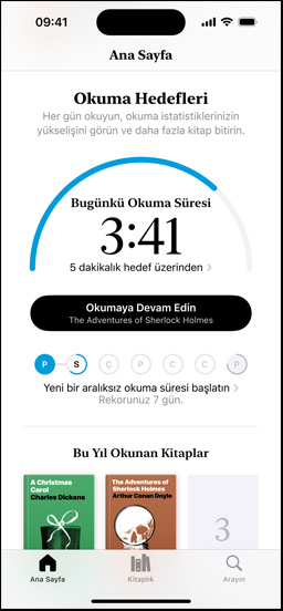 Books uygulamasında Okuma Hedefleri arayüzünü gösteren iPhone ekranı. Üst kısımda ilerlemeyi gösteren bir halka var. İlerleme halkasının altında haftalık okuma serisi görünüyor. Altta yer alan Bu Yıl Okunan Kitaplar bölümünde iki kitap gösteriliyor ve üçüncü bir kitap için boşluk yer alıyor