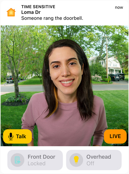 View of a doorbell camera shows a woman in a pink sweatshirt. The words “Talk” and “Live” are on screen.