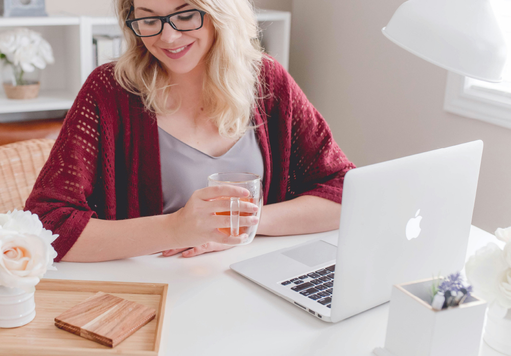 A woman using a Macbook at work