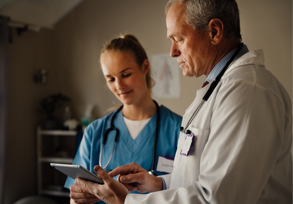 Discussion between Male and female Doctors on ipad
