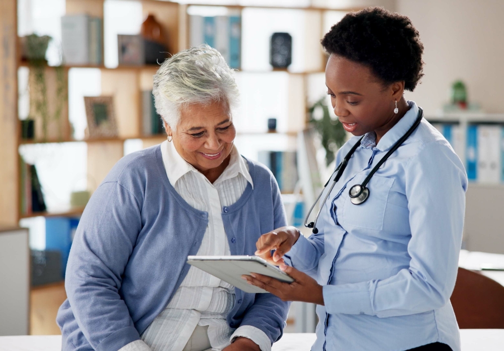 Senior woman, doctor and tablet with consultation, caregiver and care with digital results.