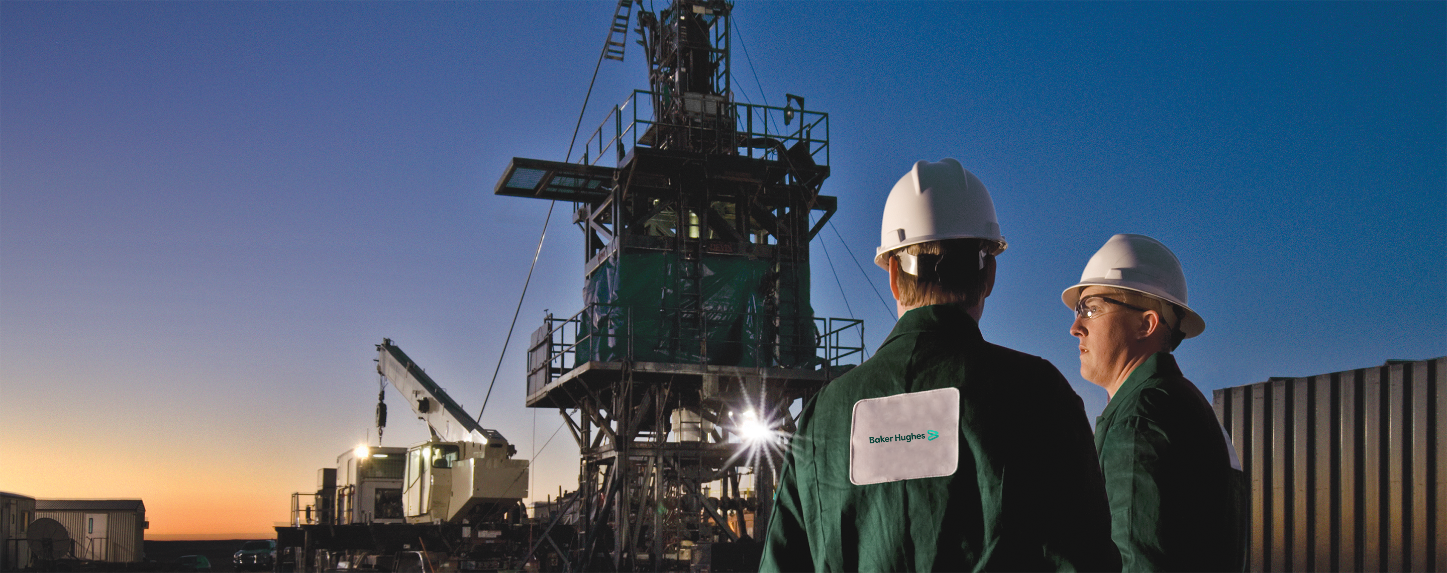 Photo of two Baker Hughes expertise at a coiled-tubing rig site.