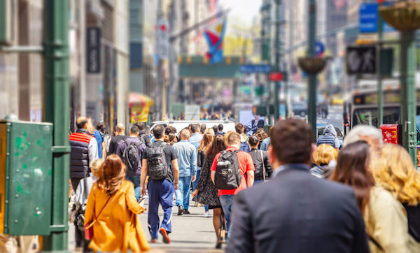 USA, New York, Manhattan streets. Skyscrapers and crowded streets, cars and busy people walking downtown in a spring sunny day