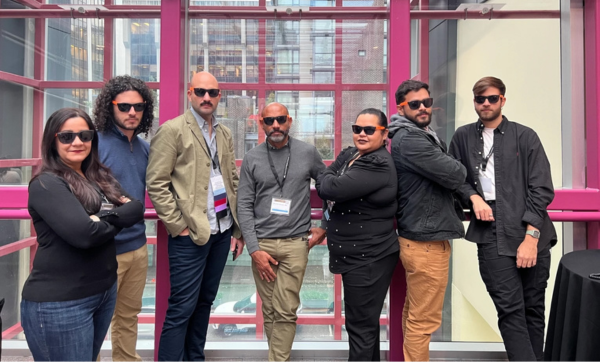 Members of the newly expanded research collaborative elTEAMnetwork stand side-by-side all wearing sunglasses