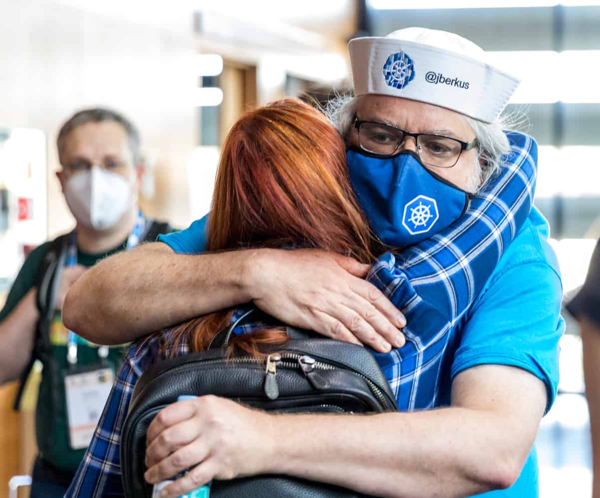 Man and woman hugging at a conference