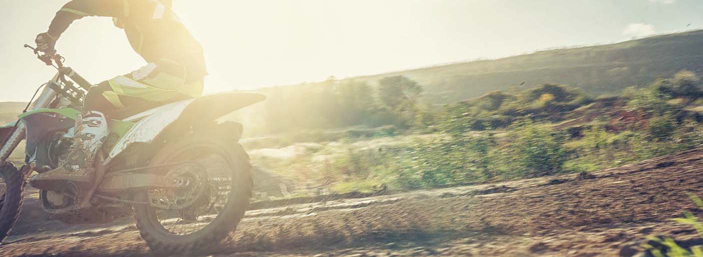 Low Angle View Of Man Riding Dirt Bike During Sunset