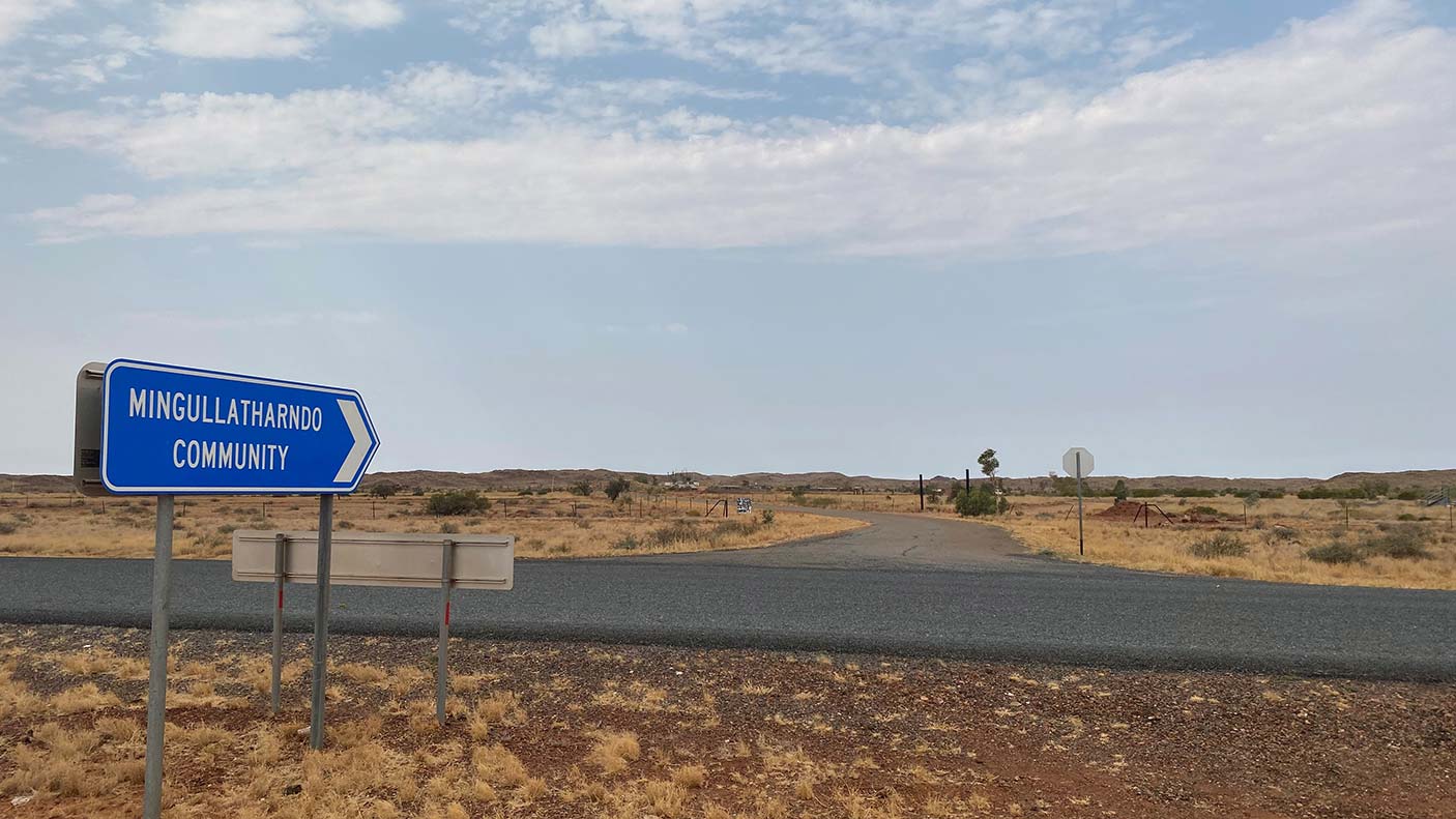 A highway sign on a remote highway pointing down the road to the Mingullatharndo Community.