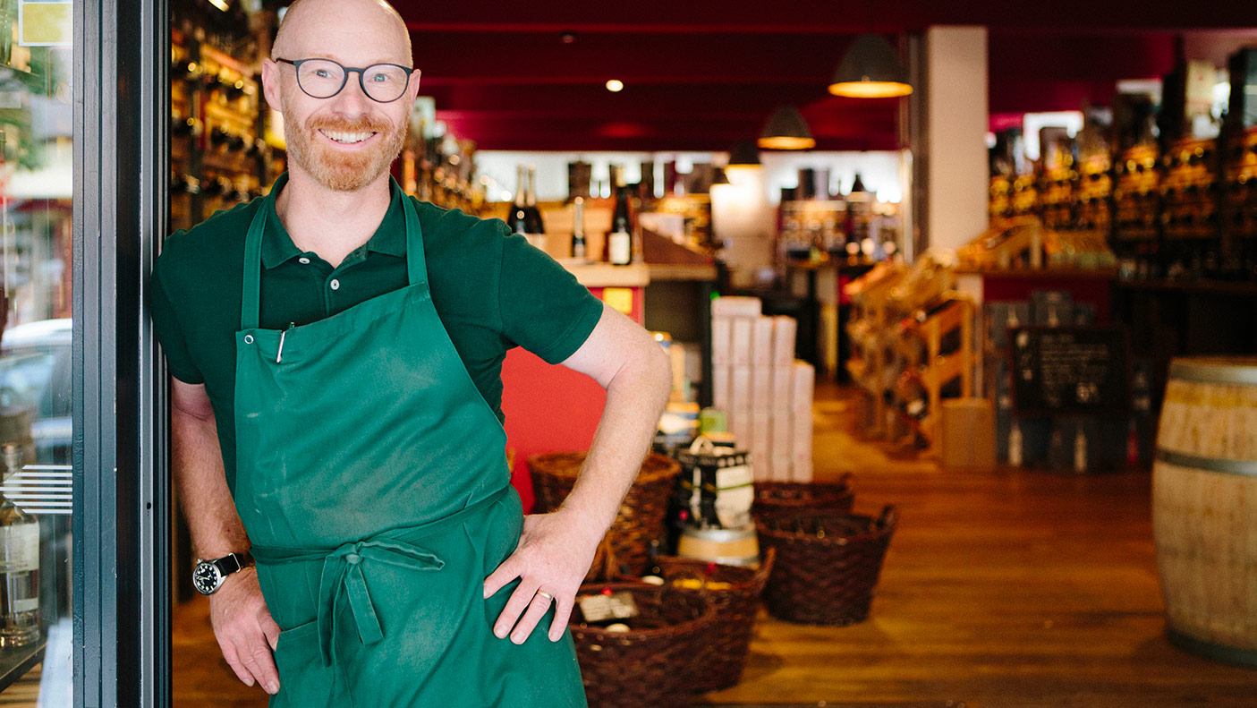 Portrait of a business owner in front of his wine shop