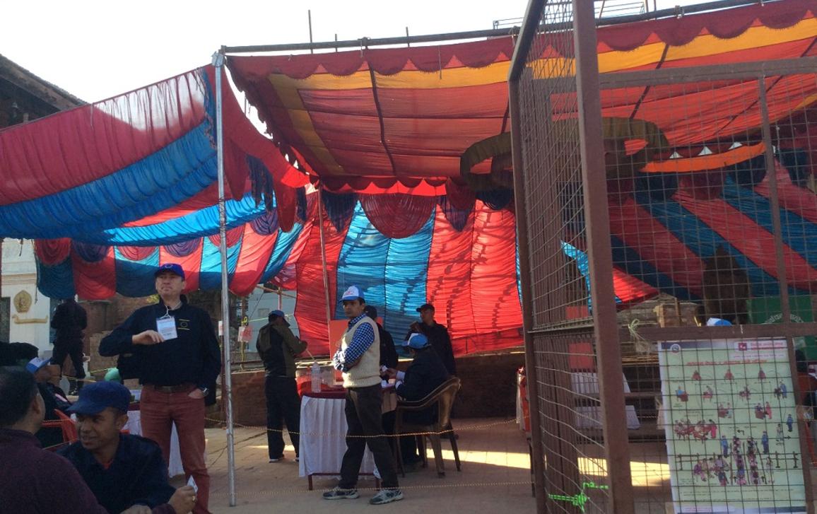 Local staff at the polling station. An EU observer standing on the side