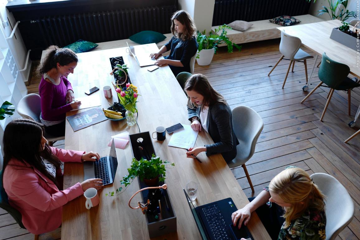 Young people are working in a coworking space. Photo by CoWomen on Unsplash