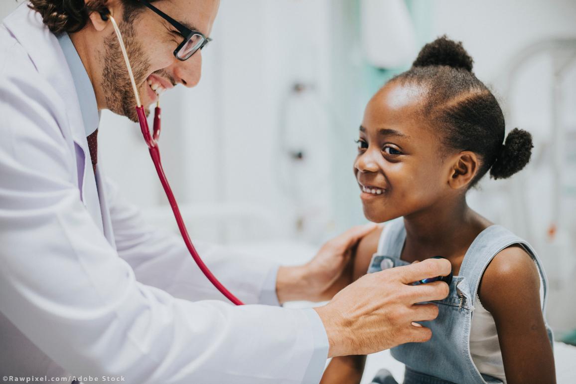 Friendly paediatrician checking a little girl's heart