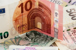 Euro note on top of Czech crowns. Photo: iStock / pfongabe33