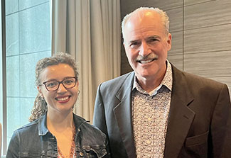 Acting Fogarty Director Peter Kilmarx (right) with Alonya Mazhanaya (left) smiling in Warsaw, Poland in June 2023.