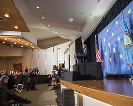 President Obama speaking to a packed auditorium at the FTC