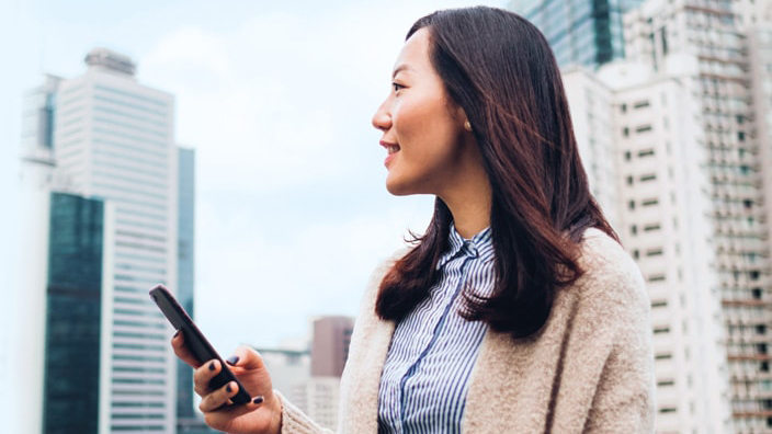 A woman is using her mobile; image used for HSBC Singapore Unit Trusts