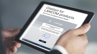 Tablet with website view of the digital assistant from LANCOM, held in two hands